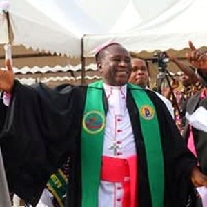 Bishop of the Methodist Sunyani Diocese rejoicing with raised arms at an open-air service, Walking in the Word livestream